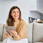Smiling woman holding a tablet