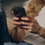 Person using smartphone while sitting