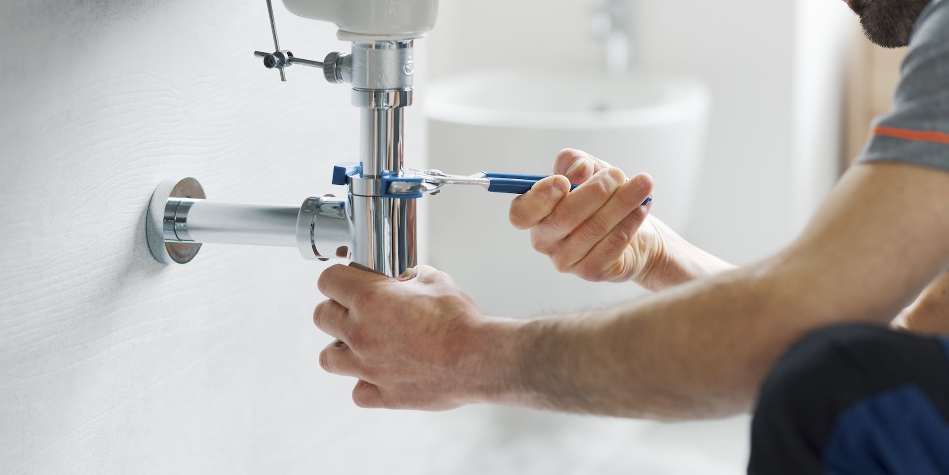 Plumber fixing sink drain pipe.